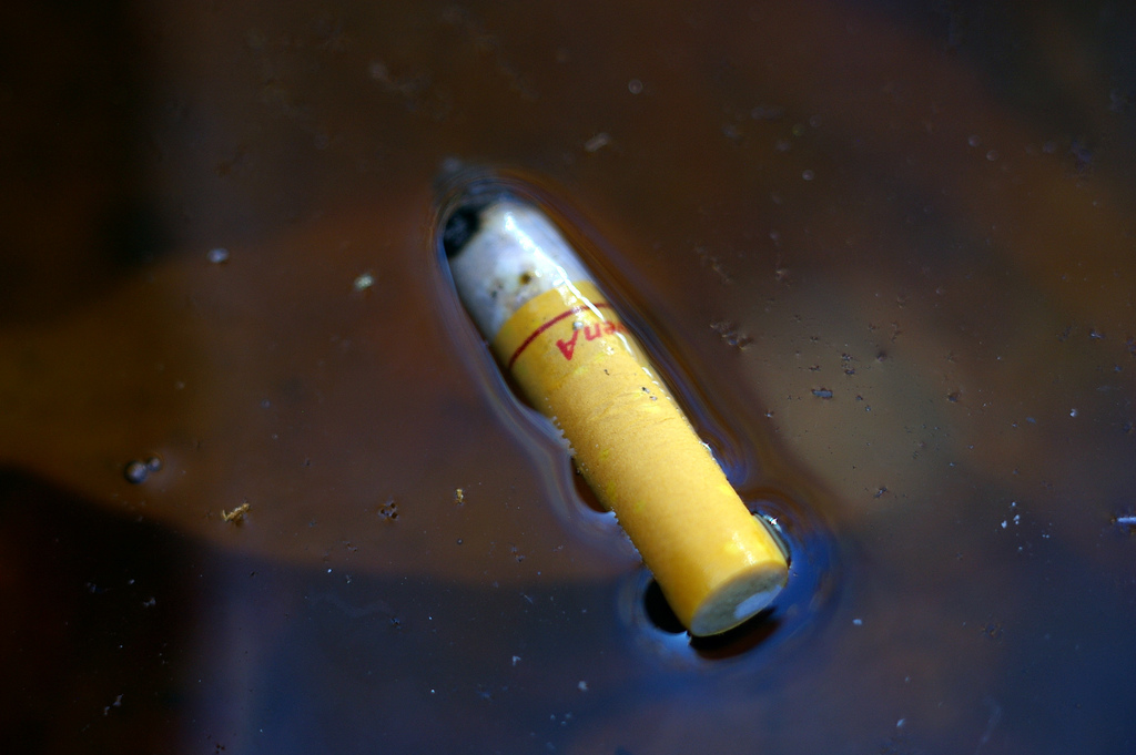 Floating cigarette butt by fortinbras floating cigarette butt photo